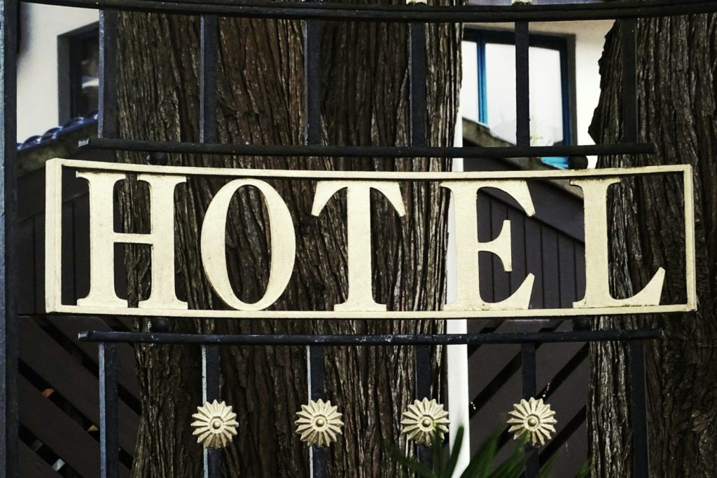 black and white wooden welcome to the beach signage
